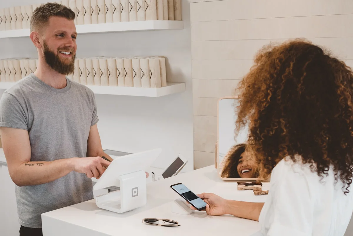 A cash transaction taking place at a pawn shop counter.